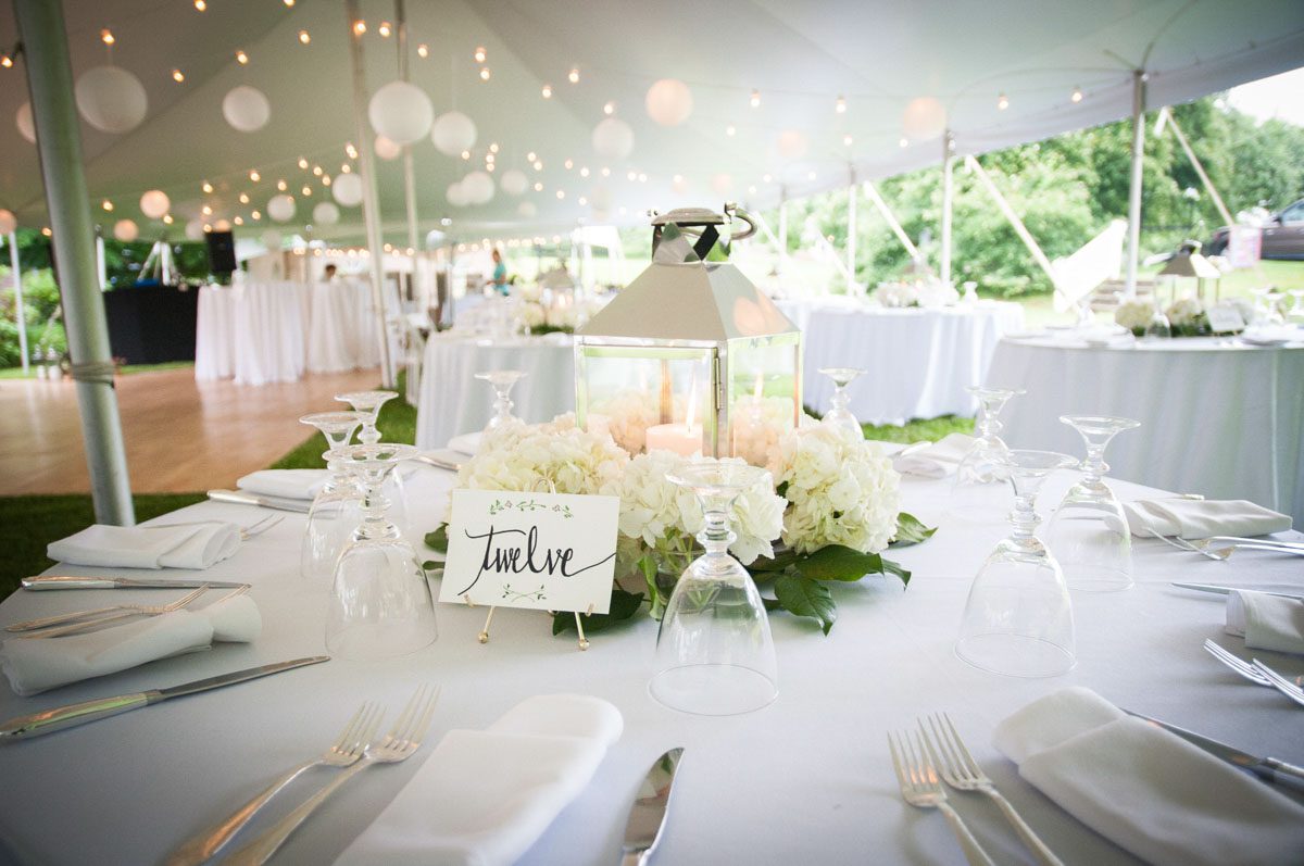 Tent Wedding at Tarrywile high-school-sweethearts-wed-at-tent-wedding-table-set-with-flowers