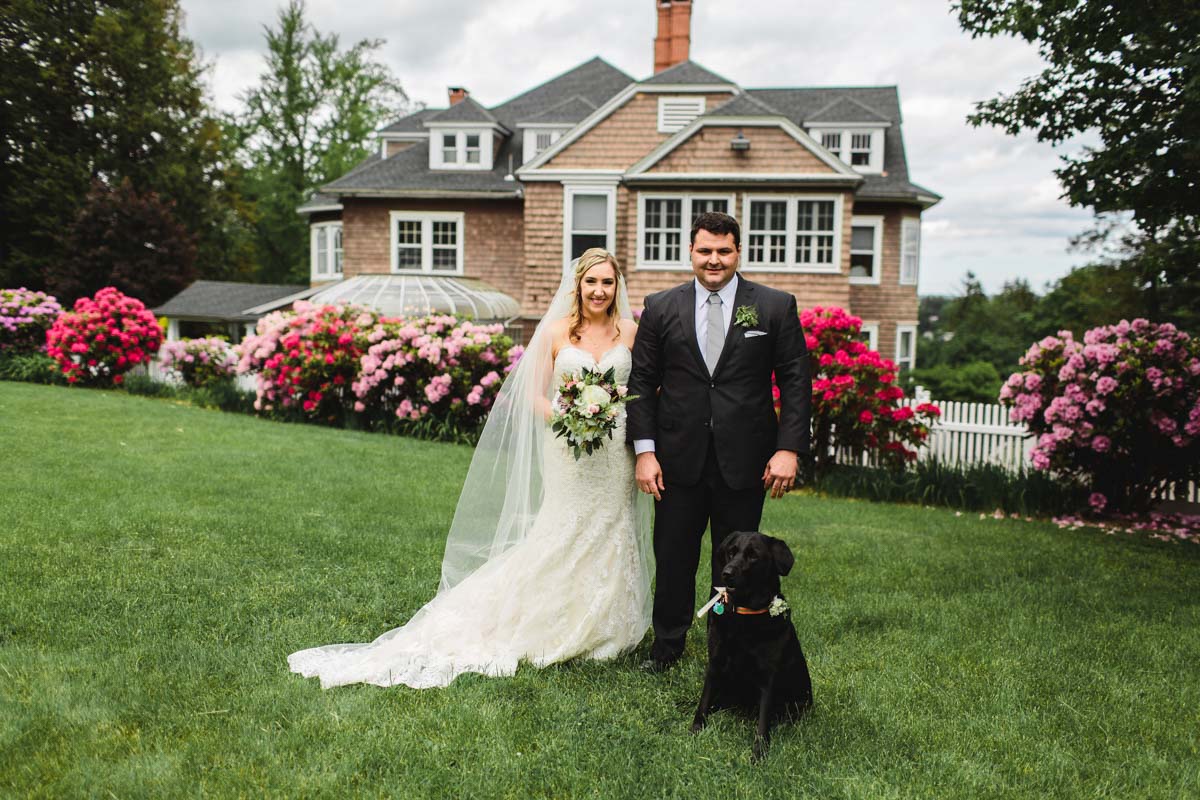 Wedding Reception at Tarrywile tent-reception-couple-standing-on-lawn-with-black-dog