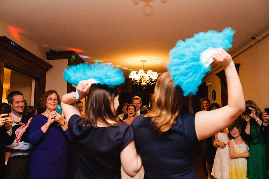 Indoor Wedding Reception guests-dancing-with-blue-fans