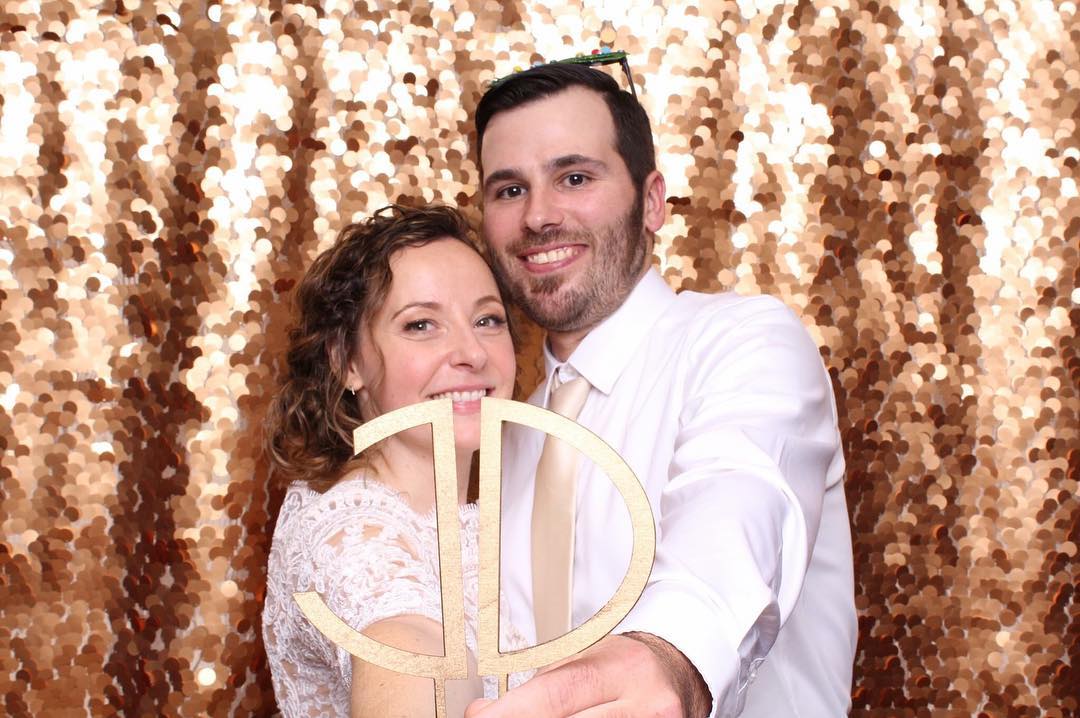 couple holding initials in photobooth